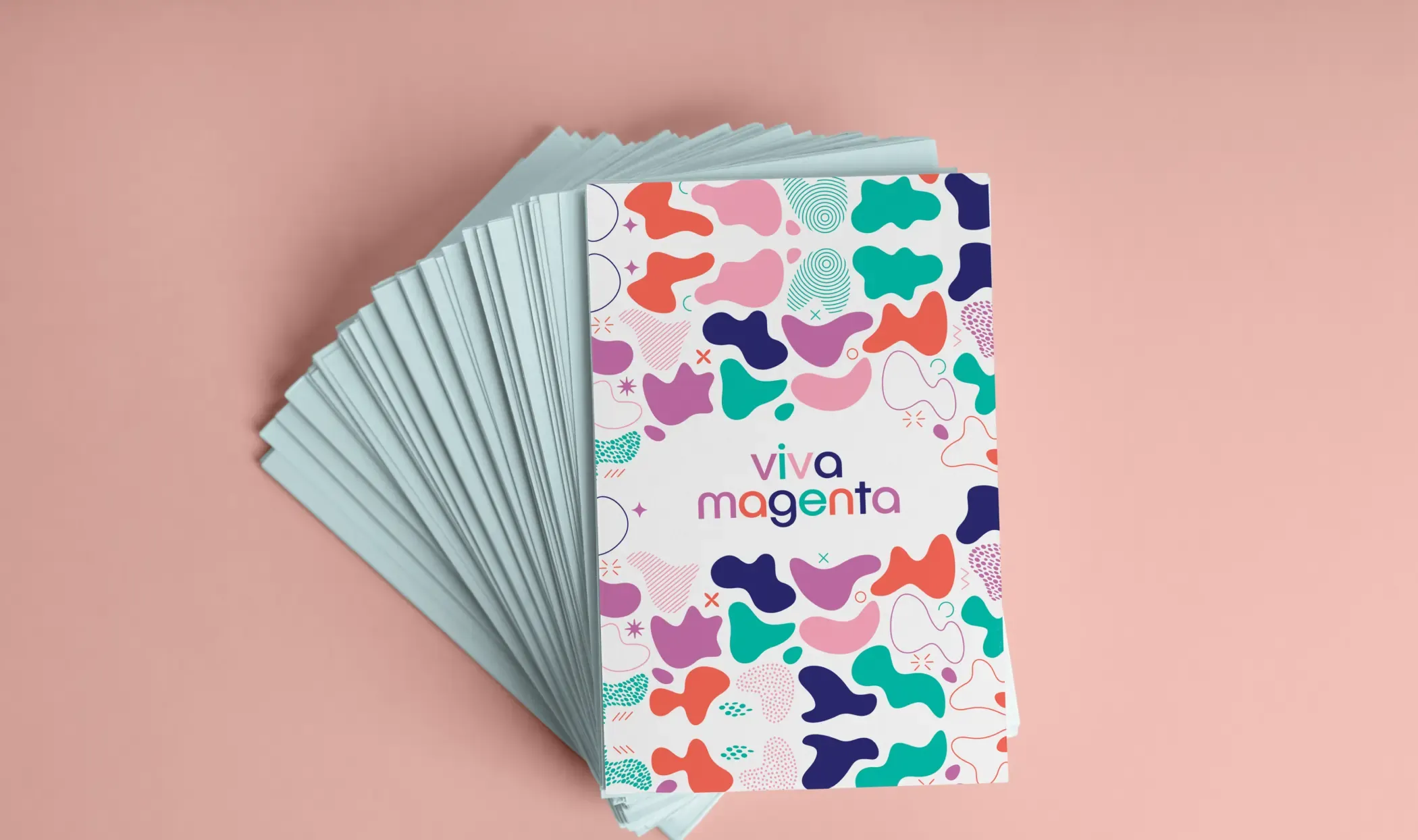 Fanned stack of patterned Viva Magenta cards on a pink background