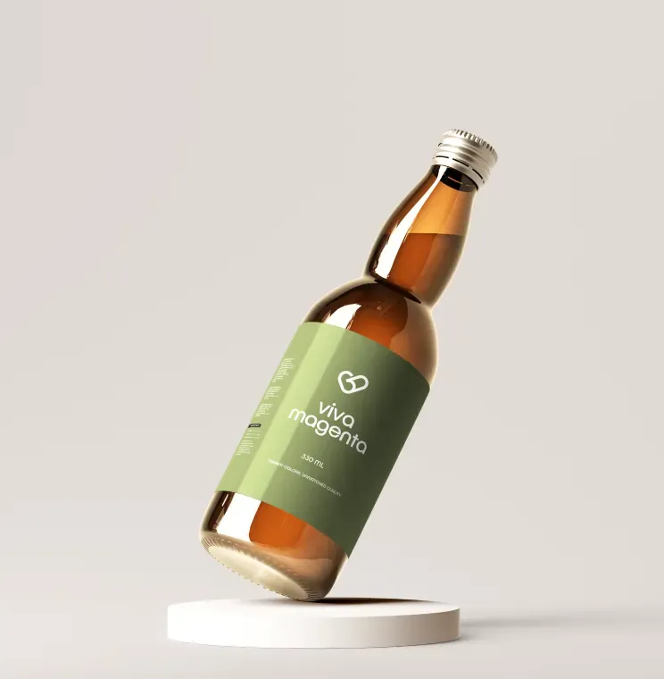 Amber bottle with a green polypropylene label on a white plinth